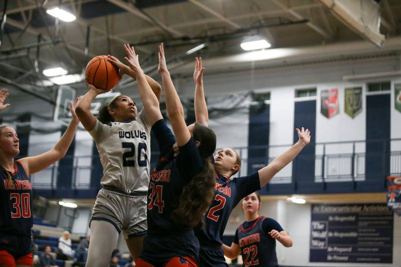 Oswego East's Jaliyah Shepard (20) puts up a shot at the basket during their basketball game between Oswego at Oswego East, Feb 10, 2026 in Oswego.
