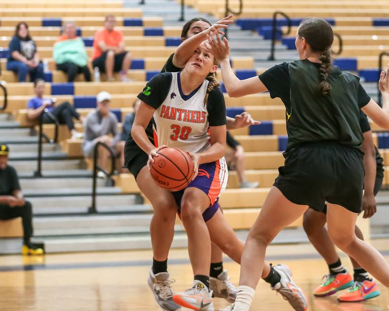 Oswego's Peyton Johnson is fouled on the way to the basket at the Oswego girls basketball shootout tournament. June 28, 2024.