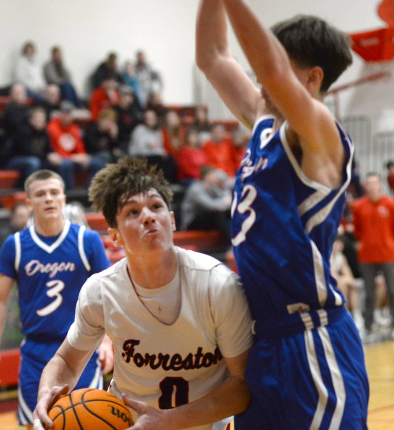 Forreston's Brendan Greenfield makes a move to the basket as Oregon's Jackson Caposey defends during a Saturday, Jan. 25, 2025 game at Forreston High School.
