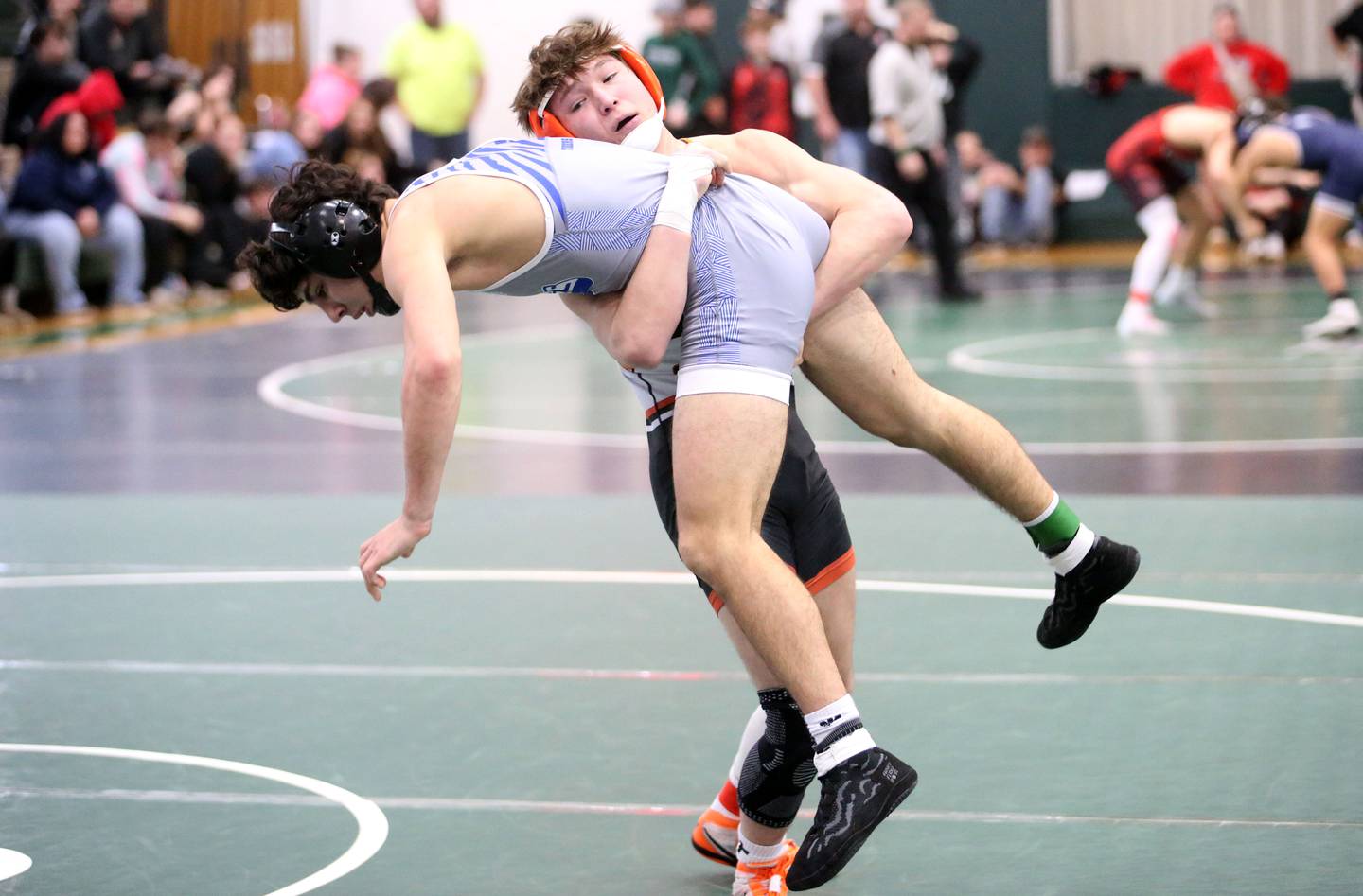 Sandwich's Cooper Corden picks up Princeton's Ace Christiansen in the 144-pound weight class during the Class 1A St. Bede Regional last season in Peru.