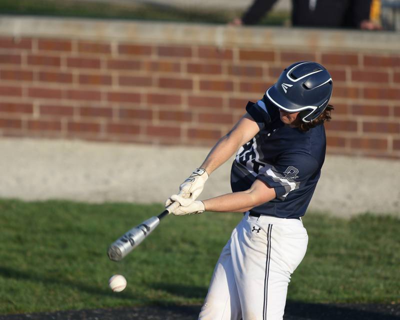 Oswego East's Jackson Petsche (22) hits a grounder during varsity baseball game between Oswego East at Joliet West.  April 10, 2023.