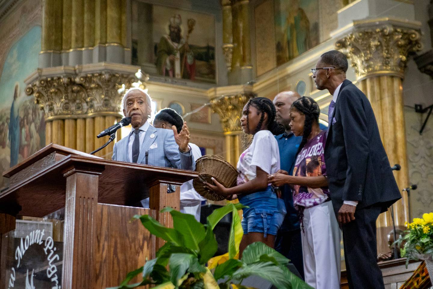 The Rev. Al Sharpton stands with the family of Sonya Massey, including her children and mother, at a rally Tuesday, July 30, 2024, in Chicago.