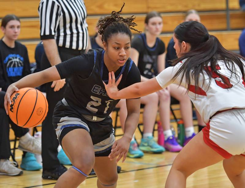 Oswego East’s Desiree Merritt drives as Benet’s Ava Thomas (right) defends during the Class 4A Benet Regional final on February 19, 2026 at Benet Academy in Lisle.