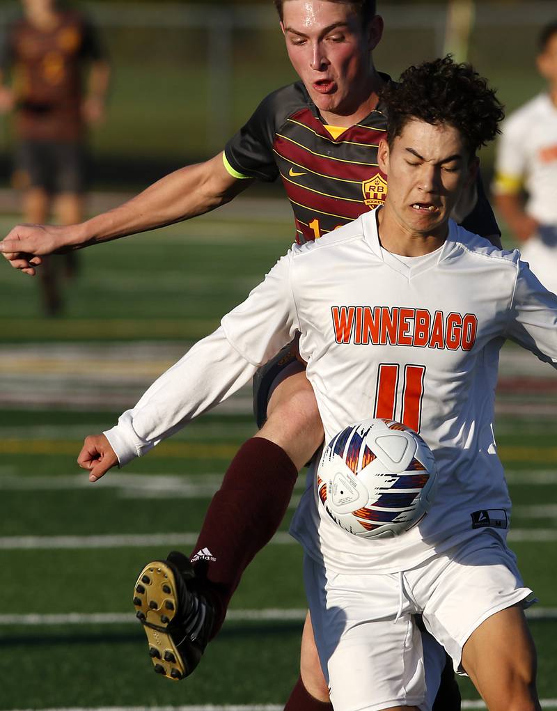 Richmond-Burton's Sean Rockwell tries to kick the ball around Winnebago's Wyatt Webb during the IHSA Class 1A Richmond-Burton Regional Final soccer match Tuesday, Oct. 17, 2023, at Richmond-Burton High School in Richmond.