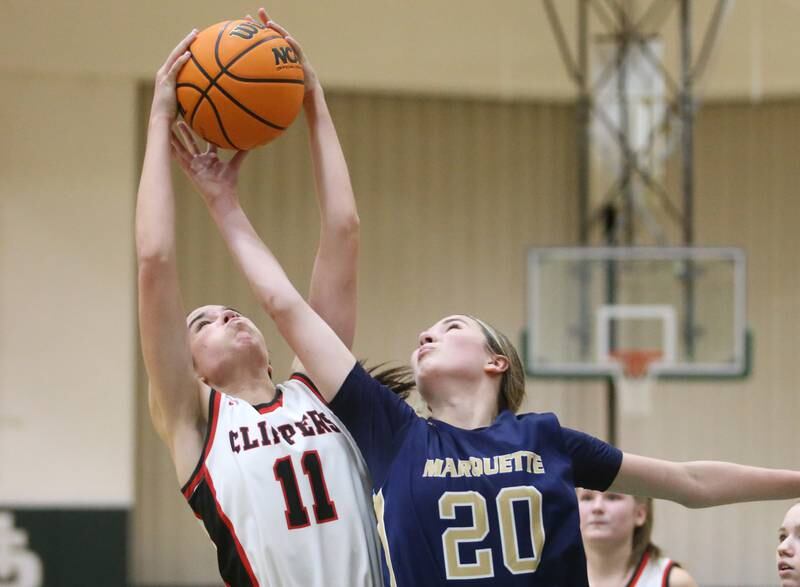 Amboy/Ohio's Tyrah Vaessen grabs a rebound over Marquette's Kaitlyn Davis during the Class 1A Regional championship on Thursday, Feb. 20, 2025 at St. Bede Academy.