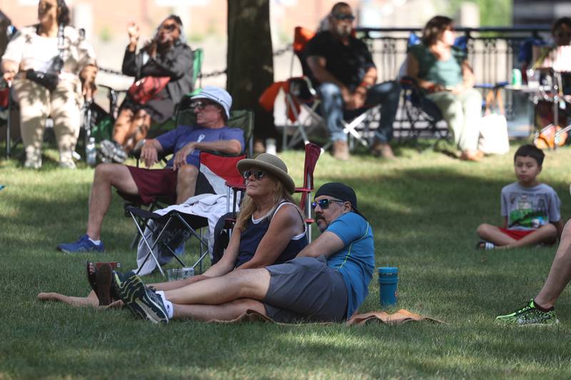 A couple relaxes in the front row while listening to the music at the 6th Annual Joliet Blues Festival on Saturday, Aug. 10, 2024 at Bicentennial Park.