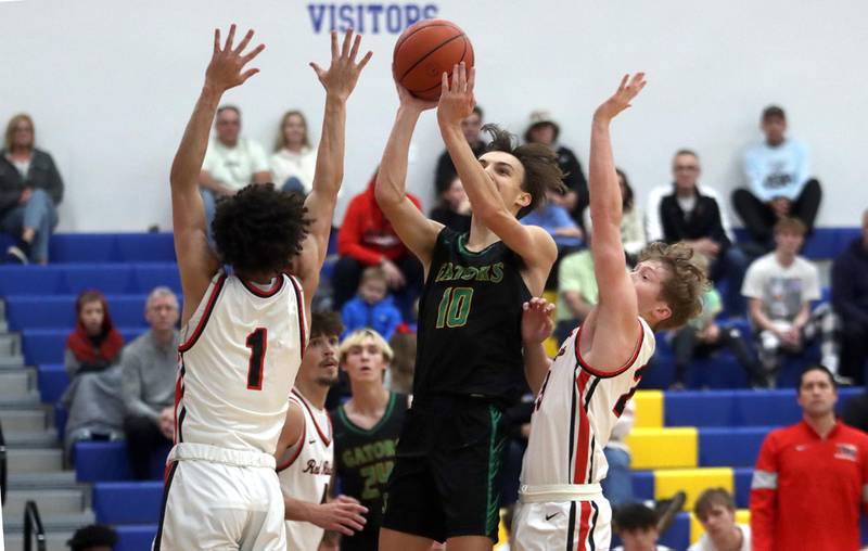 Crystal Lake South’s Cam Miller glides through Red Raider traffic during title game action of the Johnsburg Thanksgiving tournament in boys basketball on Friday.
