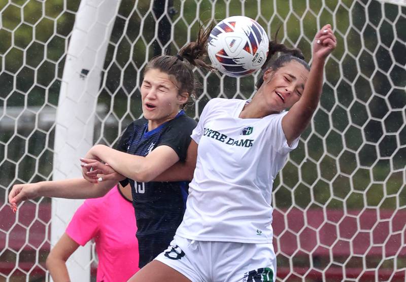 Burlington Central's Emersyn Fry (left) and Peoria Notre Dame's Ava LaFollette go up for a header during their third place game Saturday, June 1, 2024, at the IHSA Class 2A state soccer finals at North Central College in Naperville.