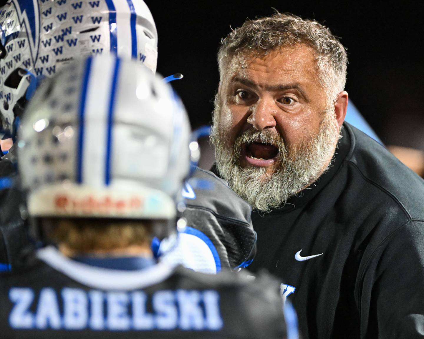 Woodstock head coach Michael Brasile talks with his team during a break in action against their Kishwaukee River Conference and crosstown rival Woodstock North on Friday, Oct. 25, 2024 at Woodstock H.S.