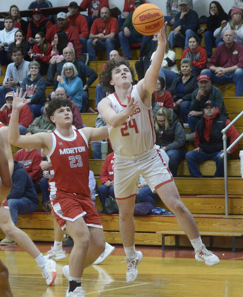 Streator’s Jacob Hagie drives past Morton’s Grant Selke for a layup in the 2nd period Wednesday at Streator.
