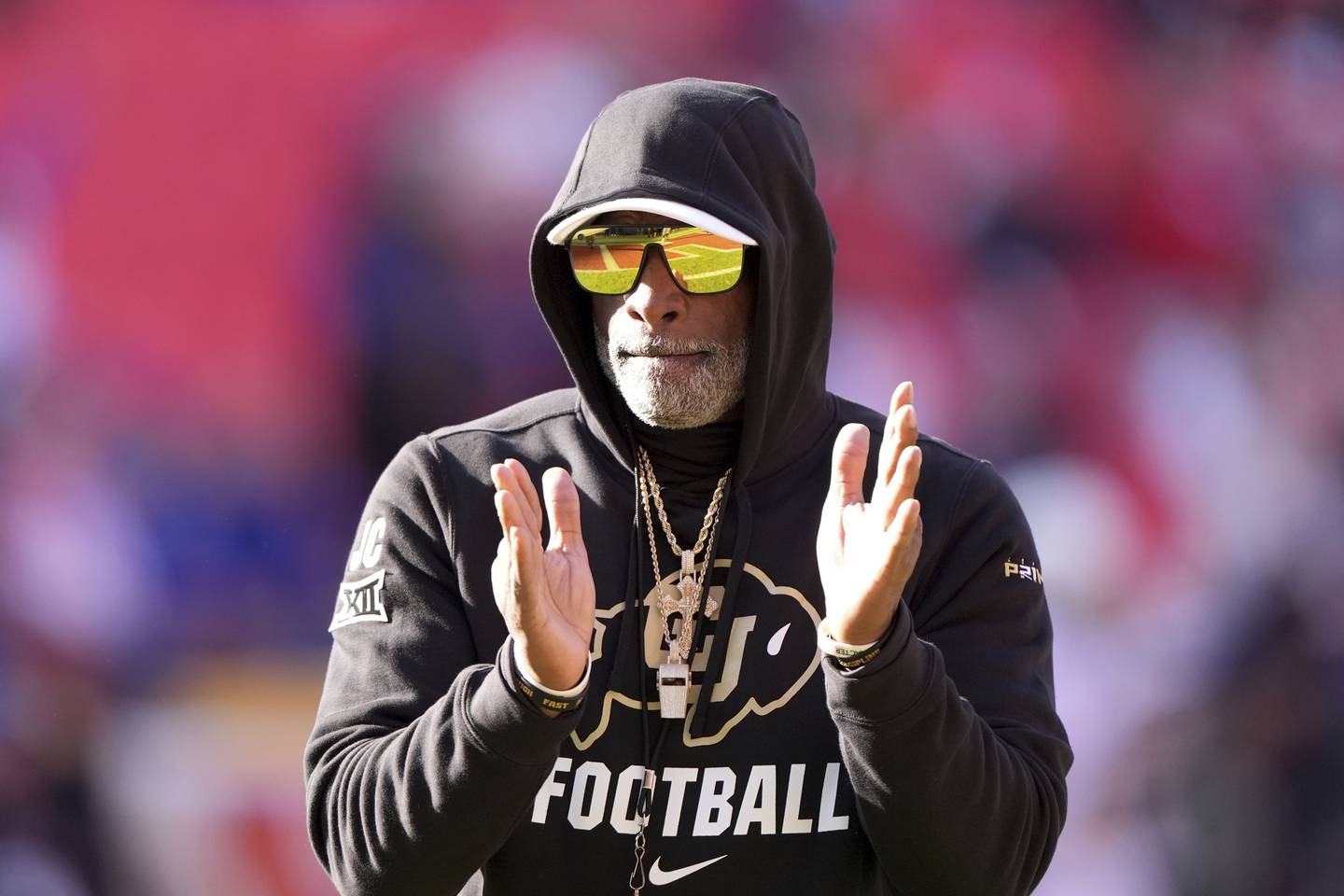 Colorado head coach Deion Sanders talks to his players before an NCAA college football game against Kansas, Saturday, Nov. 23, 2024, in Kansas City, Mo. (AP Photo/Charlie Riedel)