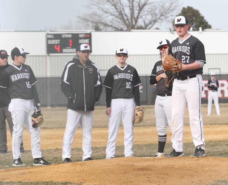 Woodland/Flanagan-Cornell's Alec Fiazier (right) warms up on the mound as his teammates watch against Streator on Wednesday, March 15, 2023 at Woodland High School.