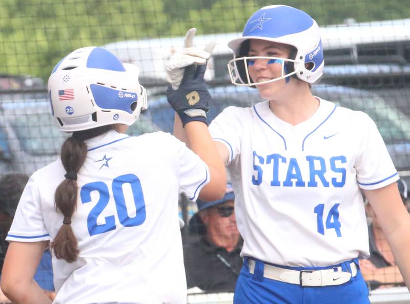 St. Charles North's Julianna Kouba hi-fives teammate Zbby Zawadzki after scoring a run against Marist during the Class 4A championship game on Saturday, June 8, 2024 at the Louisville Slugger Sports Complex in Peoria.