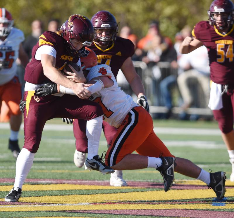 Joe Lewnard/jlewnard@dailyherald.com
Montini quarterrback Gaetano Carbonara, left, gets tackled by Byron’s Caden Considine on a run during the Class 3A semifinal game in Lombard Saturday.