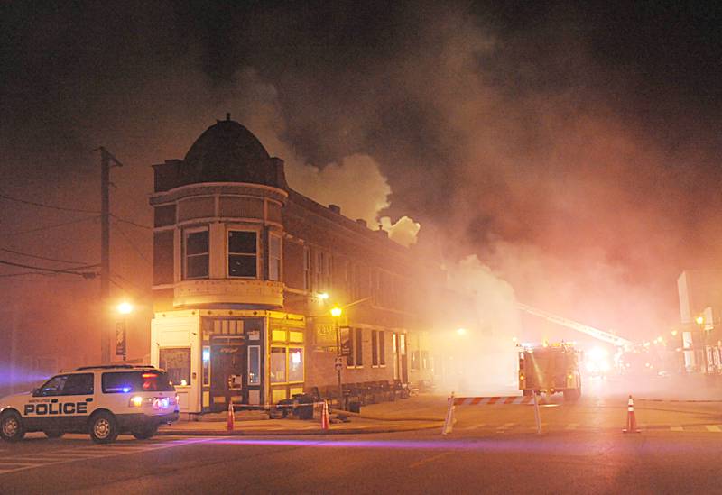 Smoke billows from an apartment outside Skoogs Pub & Grill on Sunday, May 10, 2015 downtown Utica.