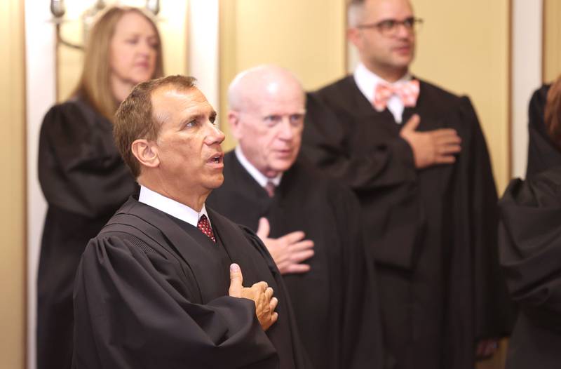 Retired judge Ronald G. Matekaitis along with other judges in attendance recite the Pledge of Allegiance prior to the swearing in ceremony of Jill K. Konen as an associate judge of the 23rd Judicial Circuit Court Friday, Sept. 23, 2022, at the DeKalb County Courthouse in Sycamore.