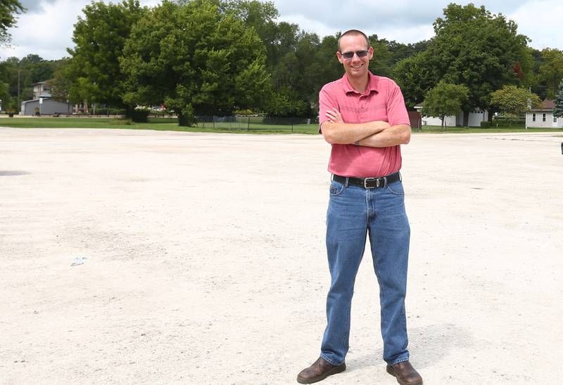 Utica mayor Dave Stewart poses for a photo behind the tornado memorial on Friday, Aug. 26, 2022 in Utica. Where Stewart is standing, will be a dozen huts that will occupy the space. The gravel lot will also be paved.