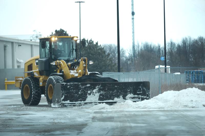 A large end loader plows snow behind the Sterling Walmart on Wednesday, Feb. 12, 2025.