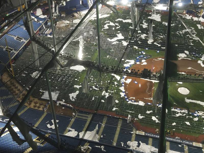 Drone images above Tropicana Field, home of the Tampa Bay Rays, show the shredded roof of the dome and the cots on the field, set up for first responders, among the debris, Thursday, Oct. 10, 2024 in St. Petersburg, Fla.  (Max Chesnes/Tampa Bay Times via AP)