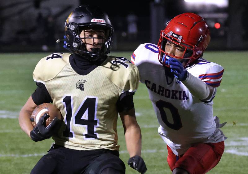 Sycamore's Josiah Mitchell tries to avoid the tackle of Cahokia's Antonio Morris during their game Friday, Oct. 25, 2024, at Sycamore High School.