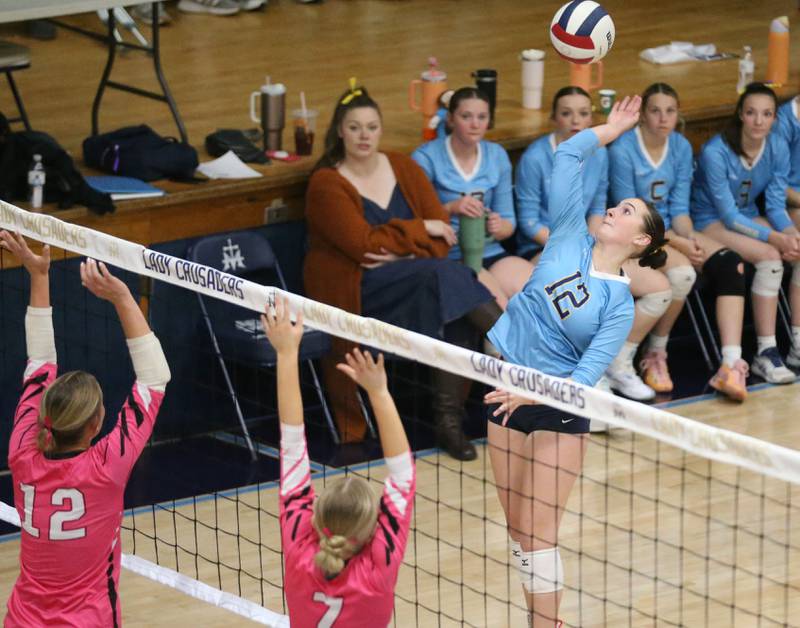 Marquette's Kinley Rick spikes the ball against Serena's Anna HJerpe and Emily Hoffman on Wednesday, Oct. 22, 2025 in Bader Gymnasium at Marquette High School.