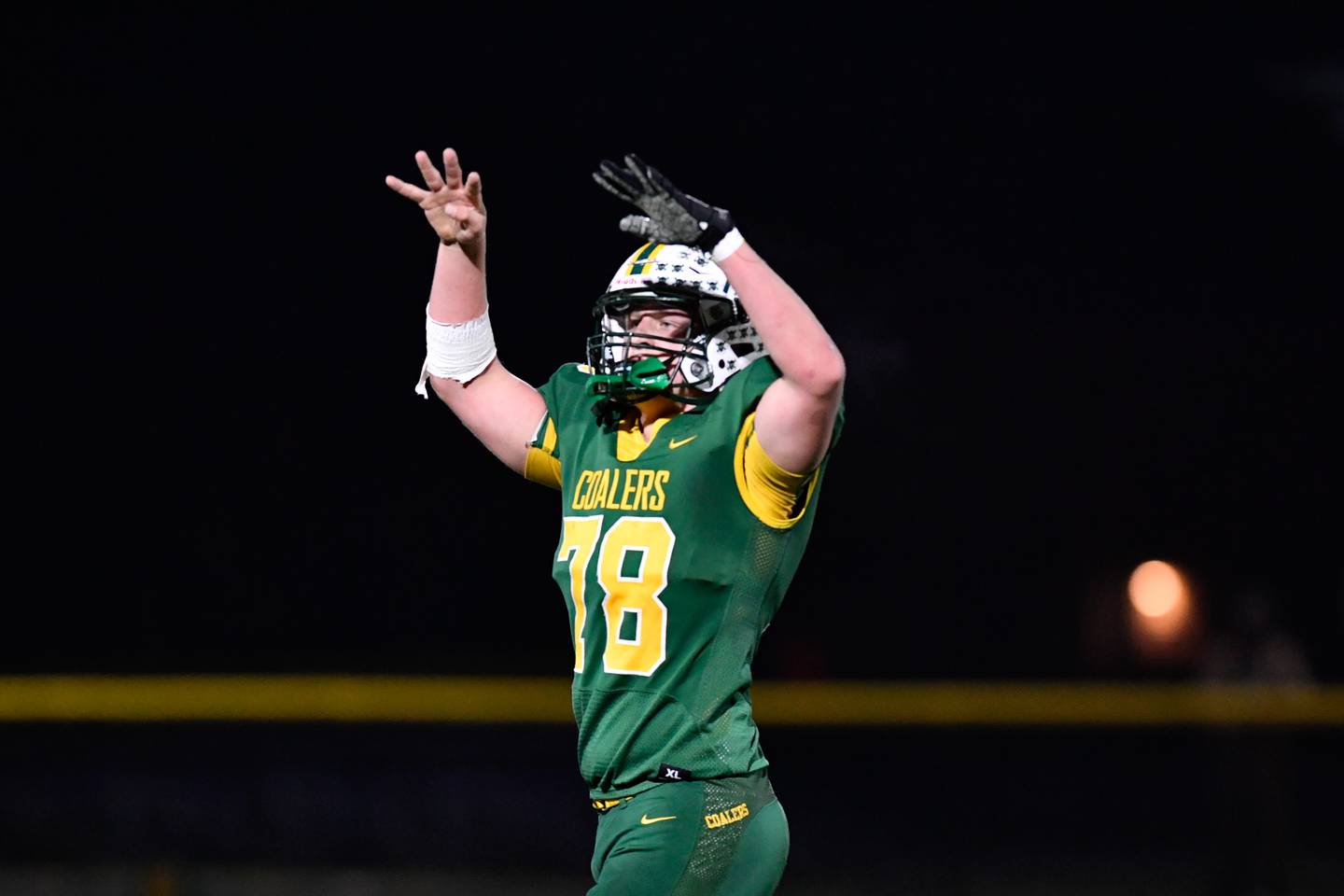 Coal City's Zander Meents hands the ball off to Landin Benson during the first round IHSA class 4A playoffs against Johnsburg on Friday Nov. 1, 2024 at Coal City High School