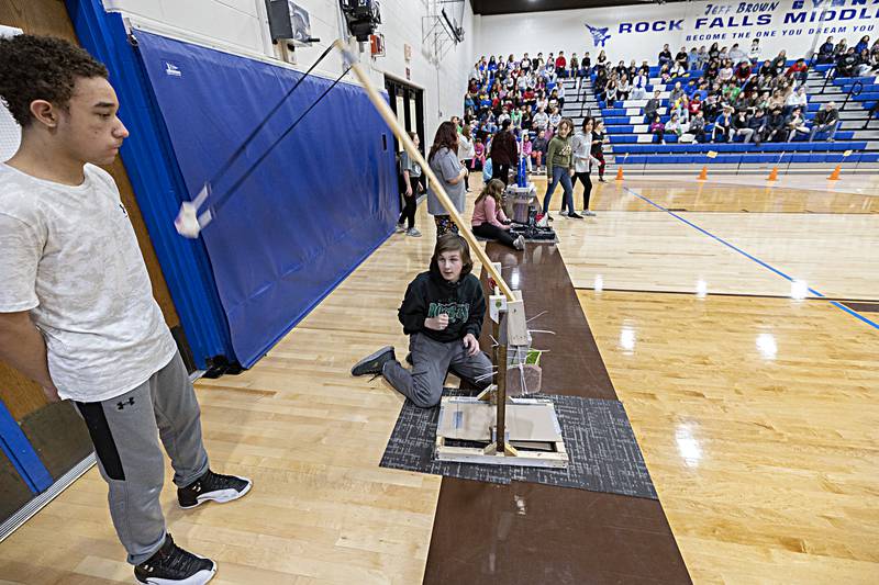 Camdon Zinke lets loose his and teammate Dashawn Boyd’s (left) trebuchet Friday, Dec. 15, 2023 at Rock Falls Middle School. The two used the sling design for their project.