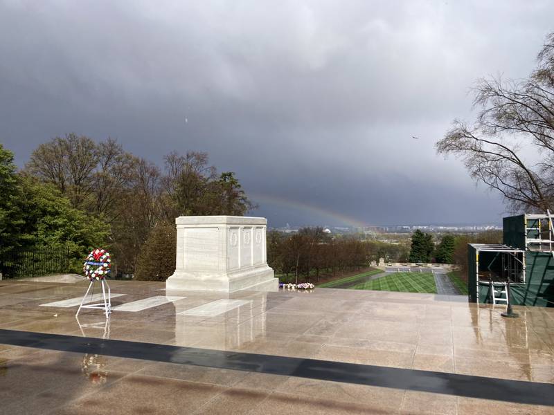 A rainbow forms in the background on a rainy day during Princeton Christian Academy's wreath laying ceremony at the Tomb of the Unknown Soldier at Arlington National Cemetery on Thursday.