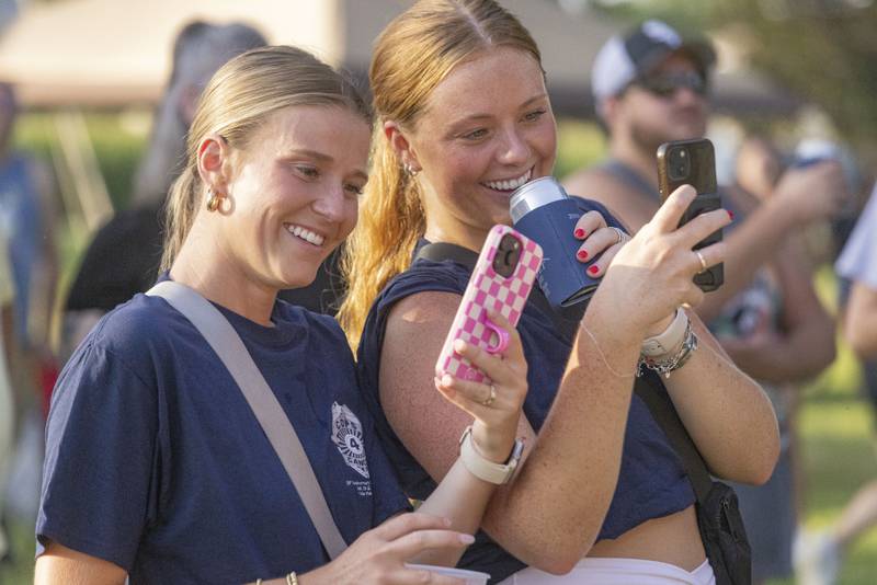 Brooke Shirley (left) and Alex Doyle (right) take a sefie during the Cops 4 Cancer concert on Friday, July 28, 2023.