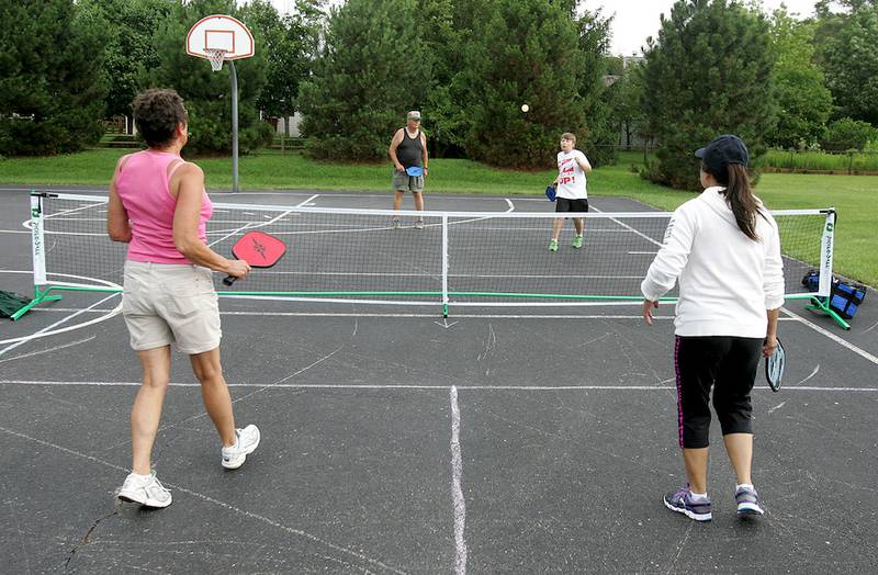 Pickleball players from left, Pam Woodruff, Woody Woodruff, Mark Woodruff and Sunny Pohlander play a match June 30, 2014, at Renwick Park in Marengo.