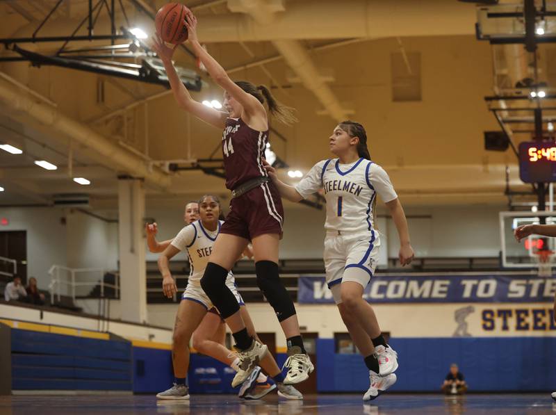 Lockport’s Alaina Peetz pulls in a rebound against Joliet Central.