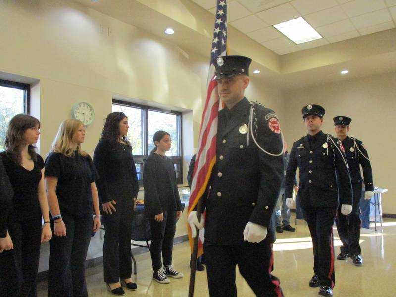 The Plainfield Fire and Police Honor Guard presents the flag as the Spectrum Youth Singers waits to sing the national anthem at the start of an annual Veterans Appreciation Breakfast held Saturday, Nov. 4, 2023 at the Plainfield Township Community Center in Plainfield.