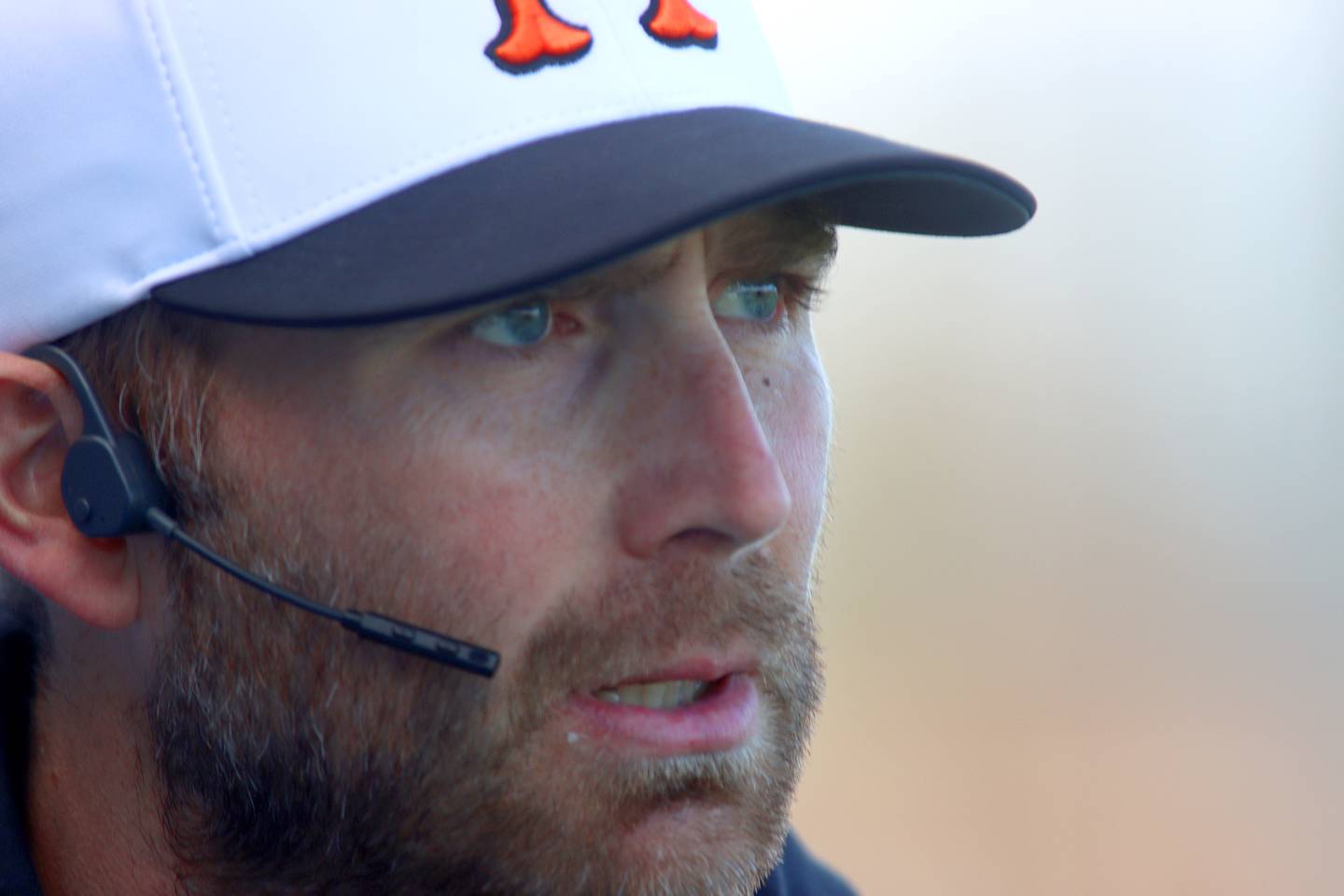 McHenry’s pitching coach Zach Badgley calls pitches via headset to catcher Kamrin Borck against Huntley in varsity baseball at McHenry Friday night.