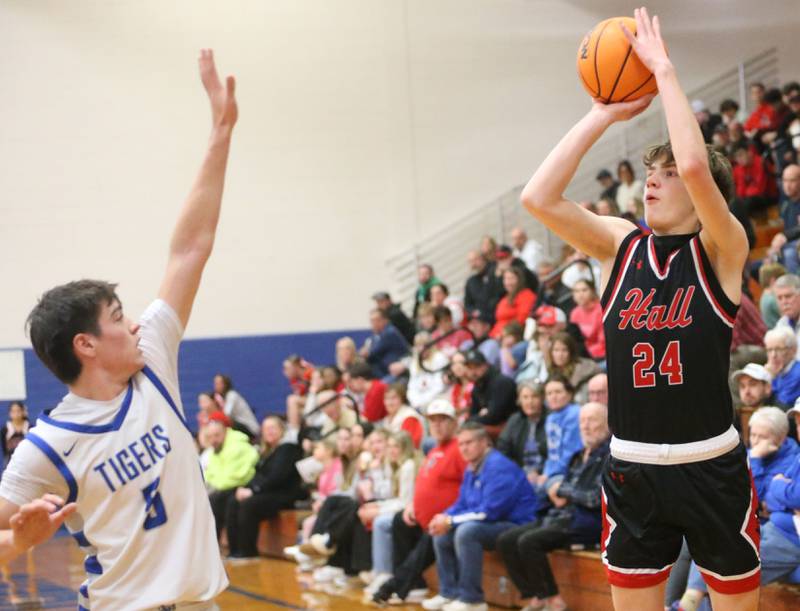 Hall's Gage Olson lets go of a jump shot over Princeton's Jack Oester on Friday, Feb. 13, 2026 at Princeton High School.