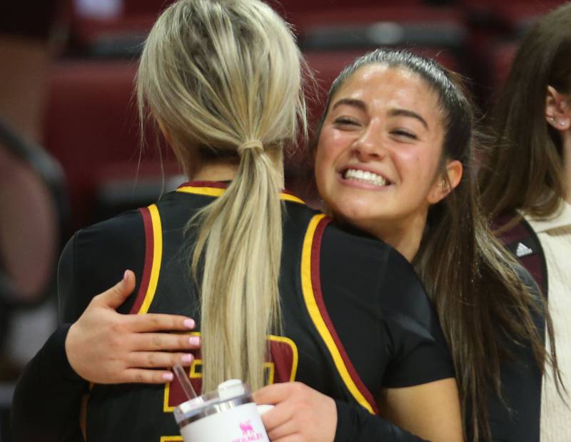 Montini's Natalie Gartlan hugs teammate Lauren Mellish after defeating Quincy Notre Dame during the Class 3A State semifinal game on Thursday, March 6, 2025 at CEFCU Arena in Normal.