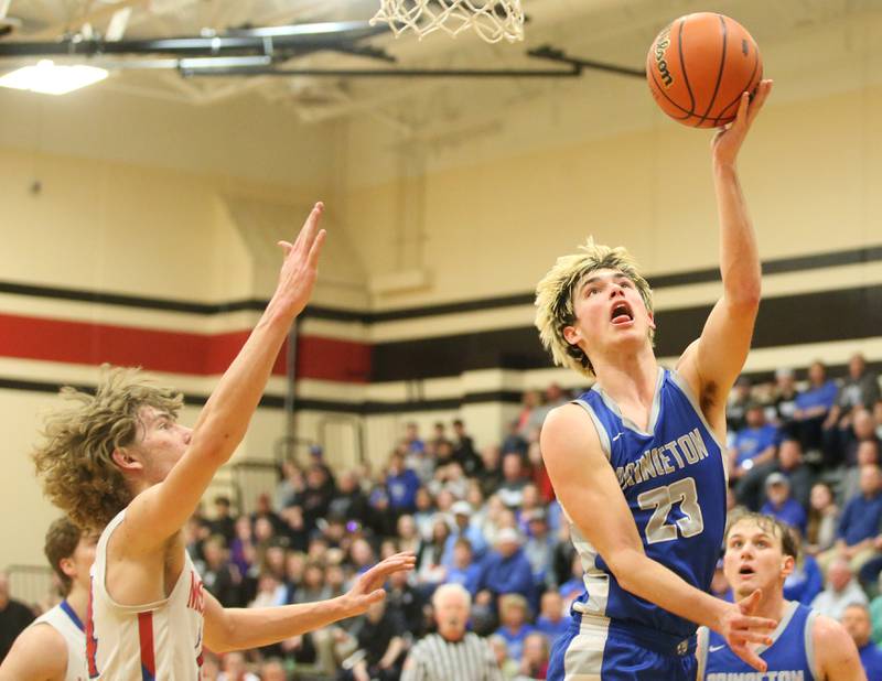 Princeton's Noah LaPorte eyes the hoop after running in the lane as Morrison's Brenden Martin arrives late to the play  during the Class 2A Regional final game on Friday, Feb. 23, 2024 at Erie-Prophetstown High School.