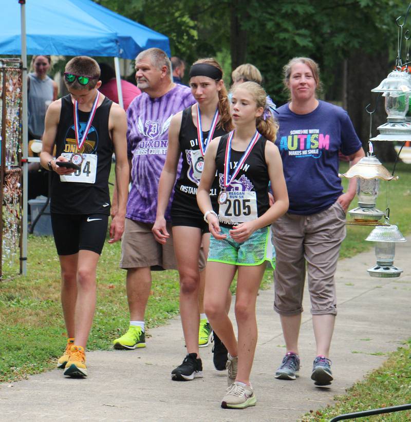 Reagan Run participants stroll through Nuts About Art Saturday, July 1, 2023 during Petunia Fest.