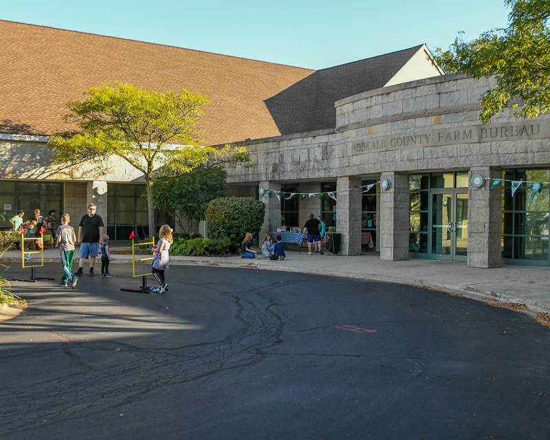 Community members enjoy games, face painting, food, and creating your own stress ball on Sunday Oct. 12, 2025, outside of the DeKalb County Farm Bureau during the 4-H carnival.
