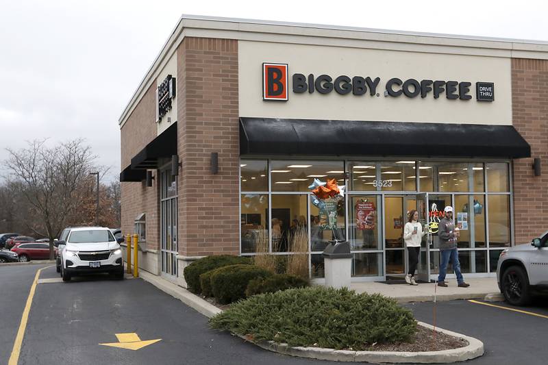 People wait in the drive through line to buy coffee on Tuesday, Dec. 10, 2024, at Biggby Coffee on their first day of business in McHenry.