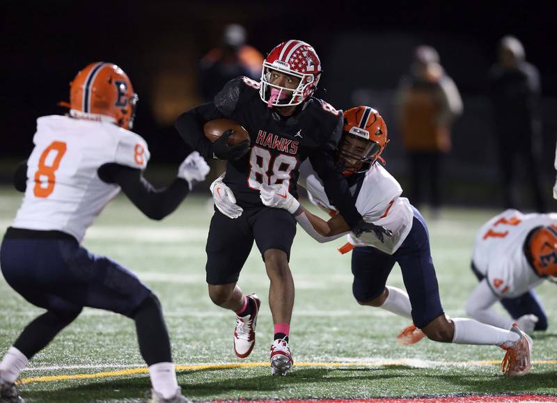 Maine South's Julian Turner (88) slips past Evanston's (8) and (7) Friday October 20, 2023 in Park Ridge.