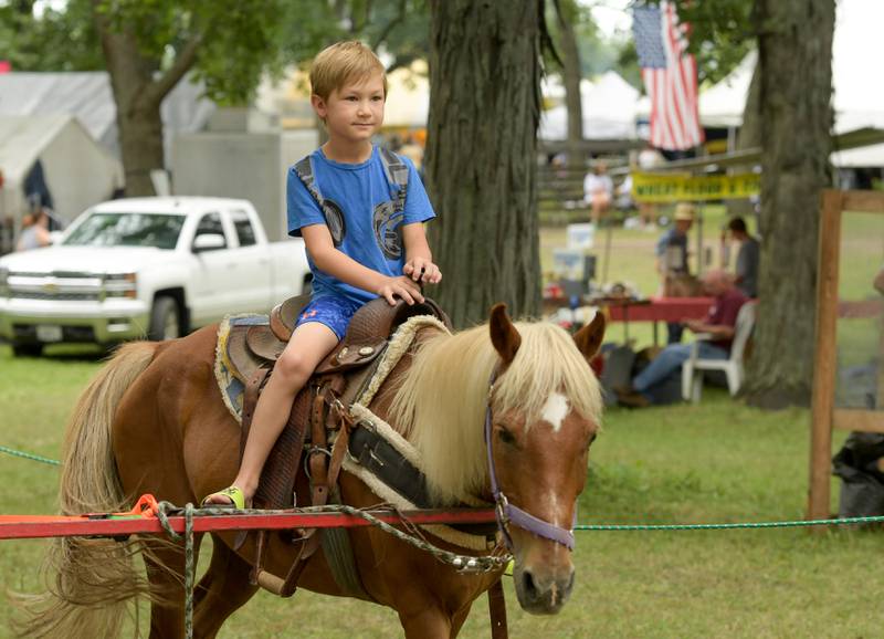Lincoln Schneider, 7 of DeKalb takes a ride on a pony during the Annual Sycamore Steam Show in Sycamore on Friday, Aug. 12, 2022.