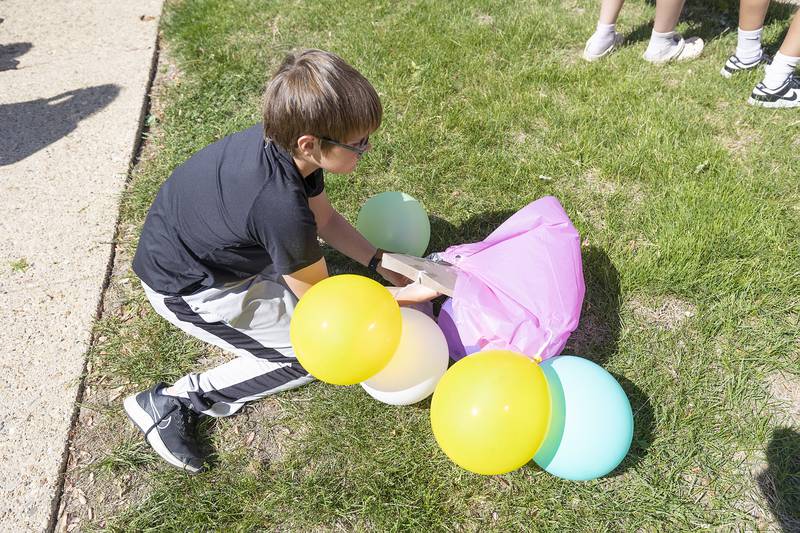 Lincoln fifth grader Dylan Johnson checks his payload Friday, May 16, 2025, after his team’s egg drop.