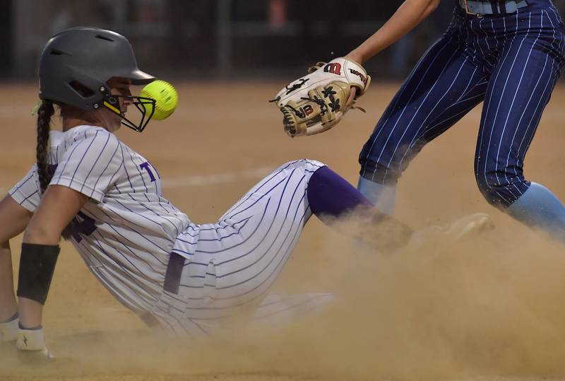 Downers Grove North’s Mia Havrilla is safe at third as she beats the throw during a game against Downers Grove South on May 14, 2026 at McCollum Park in Downers Grove.
