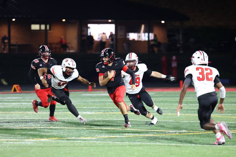 Lincoln-Way Central quarterback Drew Woodburn runs the ball past Bradley-Bourbonnais defenders during the Knight's 28-20 victory over Bradley-Bourbonnais on Friday, Oct. 3, 2025.