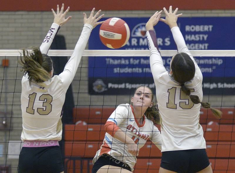 Ottawa’s Bell Markey gets this spike past the Morris duo of Tessa Shannon and Lily Hansen during the 1st set Tuesday at Ottawa.
