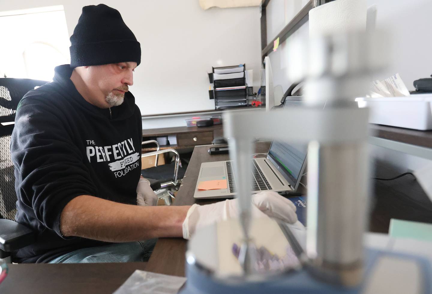 Matt Rowlee, director of outreach and drug technician at Perfectly Flawed, uses a spectrometer used to identify both legal and illegal drugs and their components on Thursday, Jan. 22, 2026, at their office in La Salle.