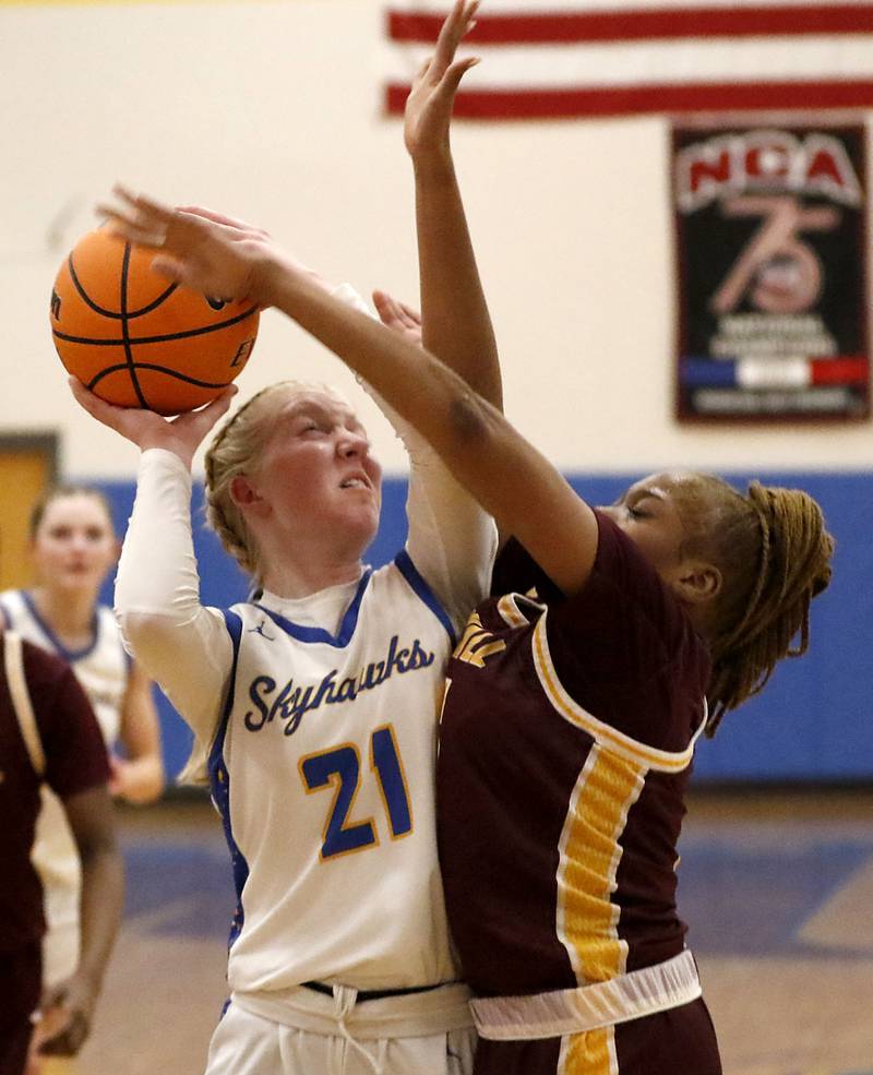 Johnsburg's Carlie Majercik tries to shoot the ball over Chicago Marshall's LaShawnda Gilbert during a IHSA Class 2A Johnsburg Sectional girls basketball semifinal game on Tuesday, February, 24, 2026, at Johnsburg High School.