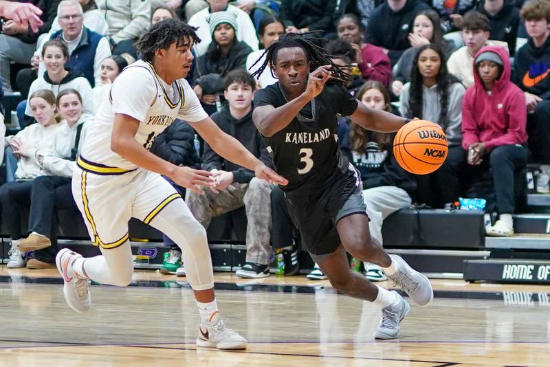 Kaneland's Marshawn Cocroft (3) drives to the basket against Yorkville Christian's Kayden Maxwell (11) during a championship final basketball game in the 61st annual Plano Christmas Classic at Plano High School on Saturday, December 28, 2024.