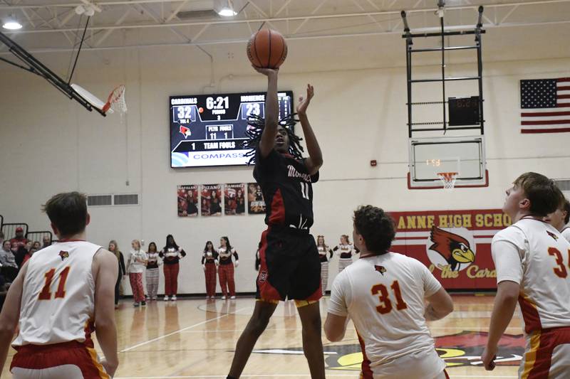 Momence's D'Angelo Hundley shoots the ball over St. Anne's Brandon Schoth during St. Anne's 61-46 victory over Momence on Tuesday December 9, 2025.