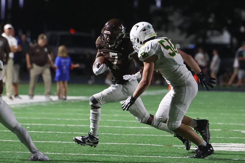 Joliet Catholic’s HJ Grigsby rushes to the outside against Providence on Friday, Sept. 1, 2023 Joliet Memorial Stadium.